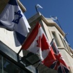 Israel and Canadian flags in Jerusalem. Photo by Joshua Spurlock.